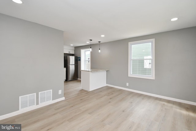 unfurnished room featuring light wood-type flooring