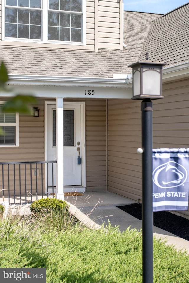 view of exterior entry with a porch