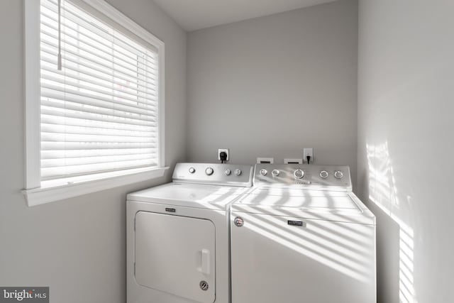 washroom with plenty of natural light and washer and clothes dryer