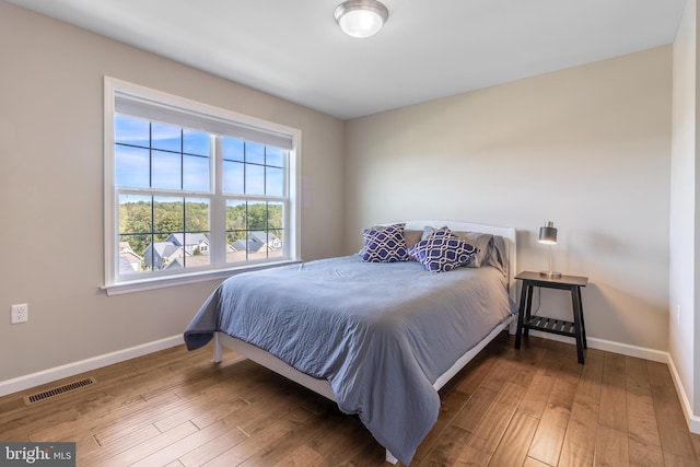 bedroom with wood-type flooring