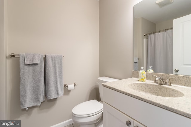 bathroom featuring vanity and toilet