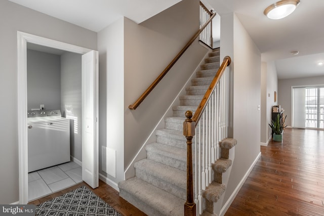 stairs featuring washer / clothes dryer and hardwood / wood-style flooring