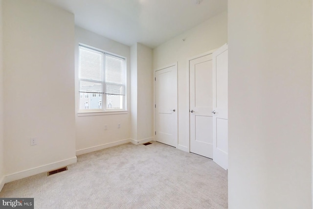 unfurnished bedroom with light carpet