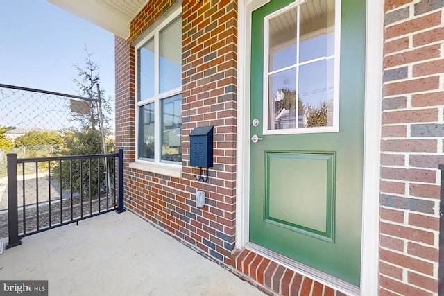 view of exterior entry featuring covered porch