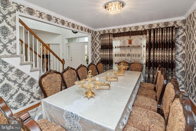 dining room with a notable chandelier and ornamental molding