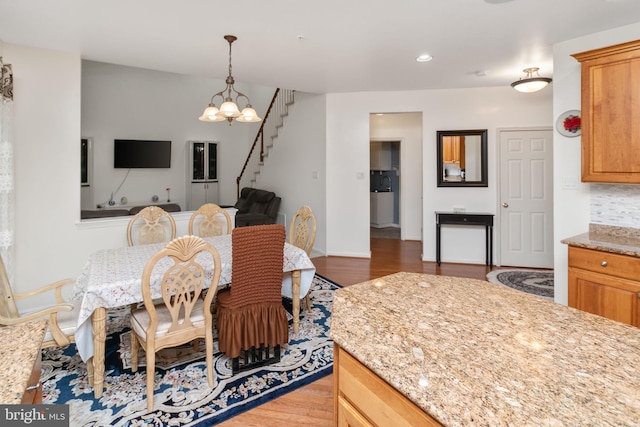 dining space featuring dark hardwood / wood-style floors and a notable chandelier