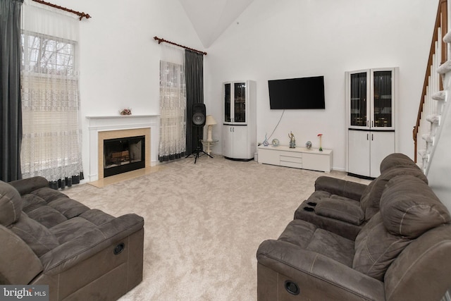 living room featuring light colored carpet and high vaulted ceiling