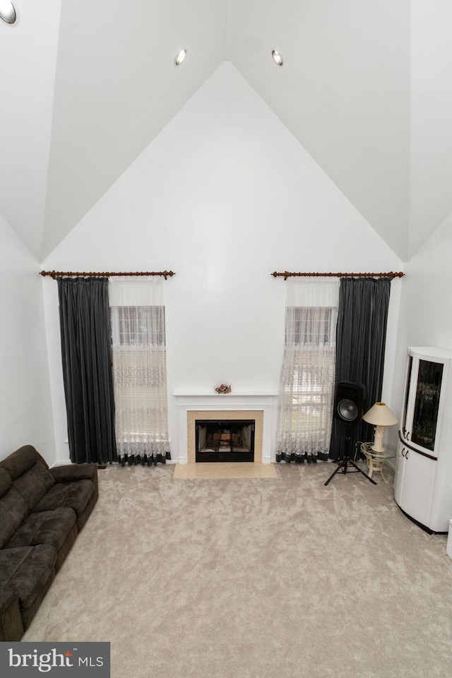 sitting room with carpet floors and vaulted ceiling