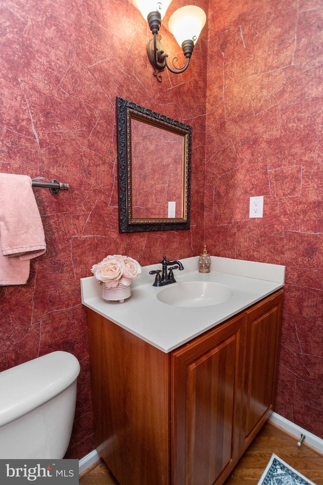 bathroom featuring vanity and toilet