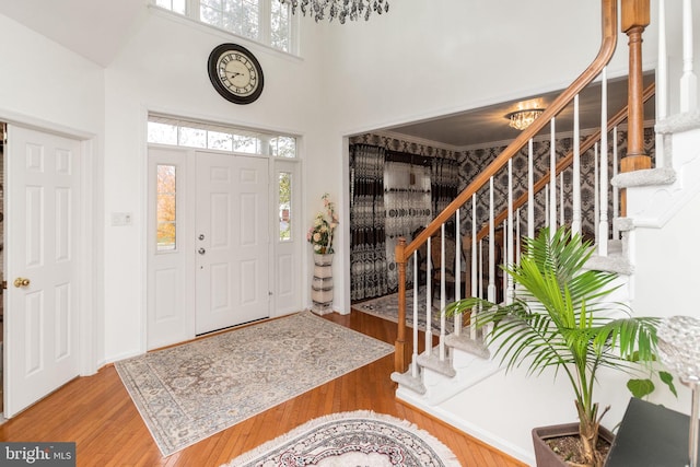 entryway featuring a notable chandelier, a high ceiling, and hardwood / wood-style flooring