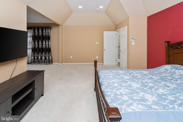 bedroom featuring vaulted ceiling and light carpet