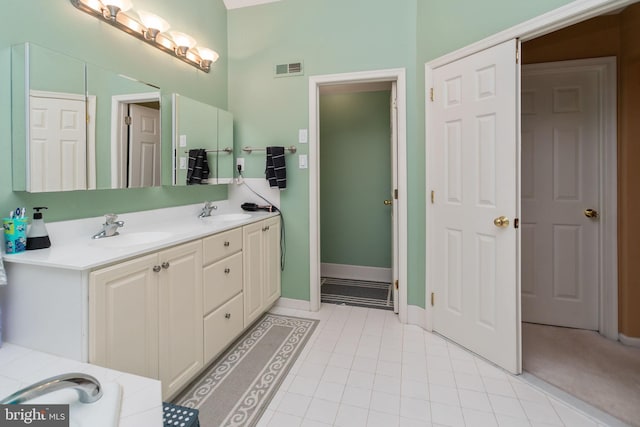 bathroom featuring vanity, a tub, and tile patterned floors