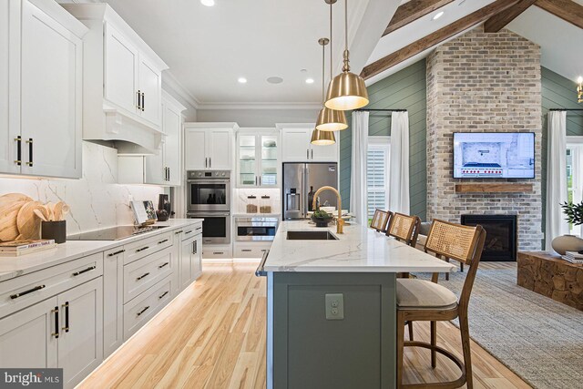 300 Friar Rock Cir, Havre De Grace, MD 21078 - kitchen with light wood-style floors, a sink, a brick fireplace, and stainless steel appliances