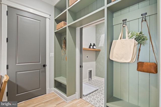 mudroom with baseboards and wood finished floors