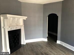 unfurnished living room featuring dark hardwood / wood-style flooring