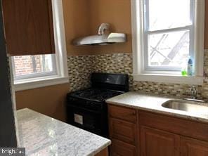 kitchen featuring black range oven and sink