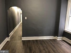 spare room with dark hardwood / wood-style floors