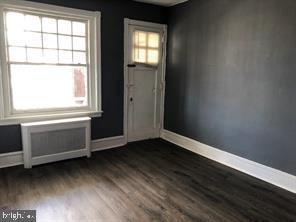 entryway featuring plenty of natural light and dark hardwood / wood-style flooring