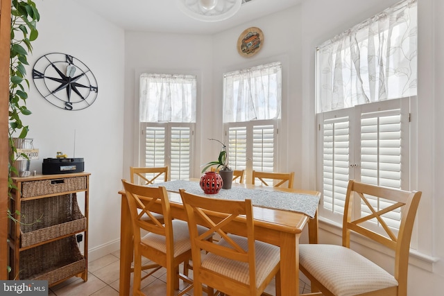 dining space featuring light tile patterned floors