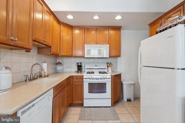 kitchen with light tile patterned flooring, tasteful backsplash, sink, and white appliances