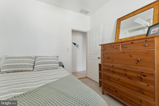 bedroom with light carpet and ceiling fan