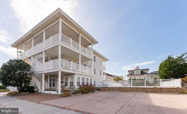 view of front of property featuring a porch and a balcony