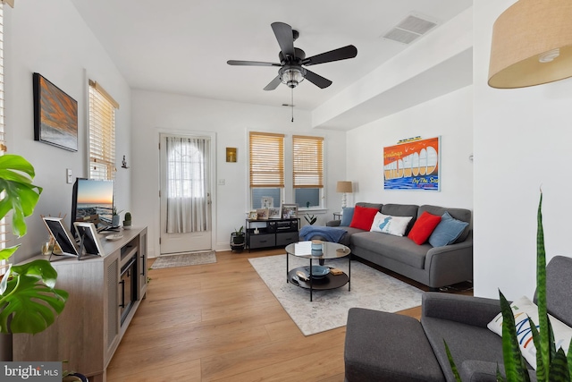 living room featuring light wood-type flooring and ceiling fan