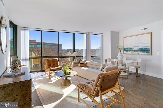 living room with floor to ceiling windows and dark hardwood / wood-style floors