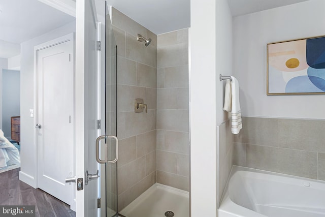 bathroom featuring independent shower and bath and hardwood / wood-style flooring