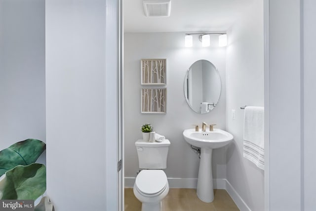 bathroom with toilet and tile patterned floors