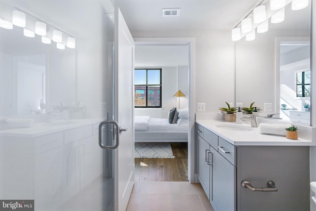 bathroom with a wealth of natural light, hardwood / wood-style flooring, and vanity