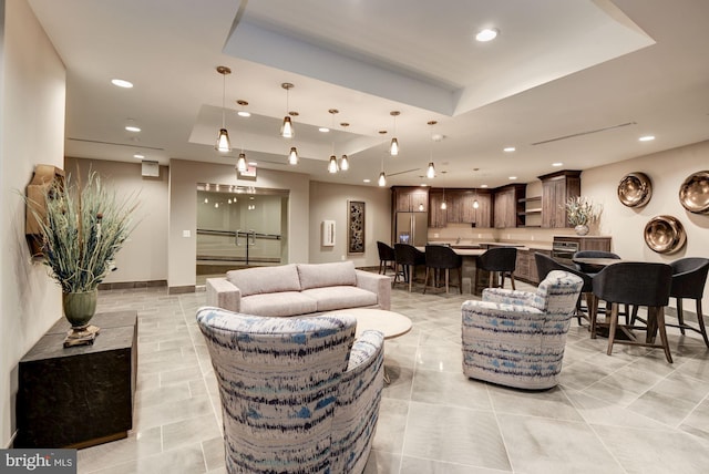 living room featuring a raised ceiling