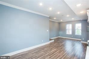 spare room with ornamental molding and hardwood / wood-style floors