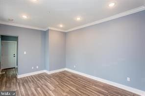 unfurnished room with crown molding and hardwood / wood-style flooring