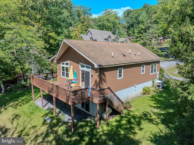 back of house with a wooden deck and a lawn