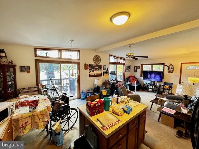 interior space with lofted ceiling with beams and ceiling fan