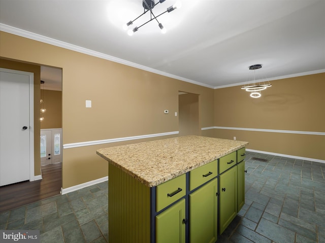 kitchen with crown molding, a center island, pendant lighting, and green cabinets