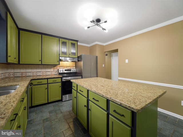 kitchen featuring ornamental molding, a kitchen island, green cabinetry, appliances with stainless steel finishes, and decorative backsplash