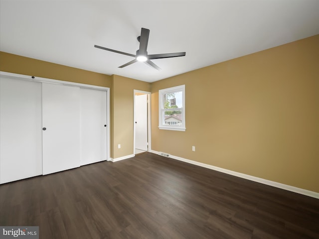 unfurnished bedroom with a closet, ceiling fan, and dark hardwood / wood-style floors