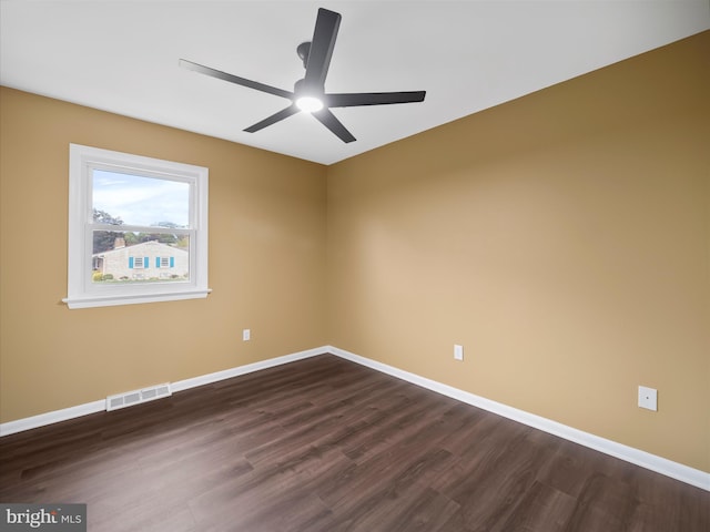 spare room with ceiling fan and dark hardwood / wood-style flooring