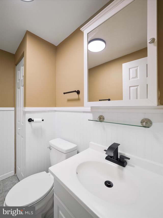 bathroom featuring vanity, toilet, and tile patterned floors