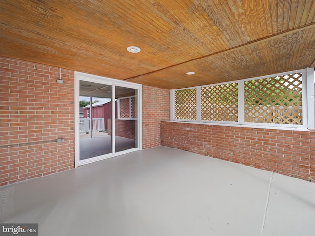 unfurnished sunroom with wooden ceiling