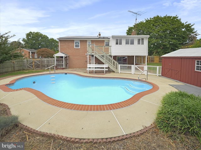 view of pool featuring a shed