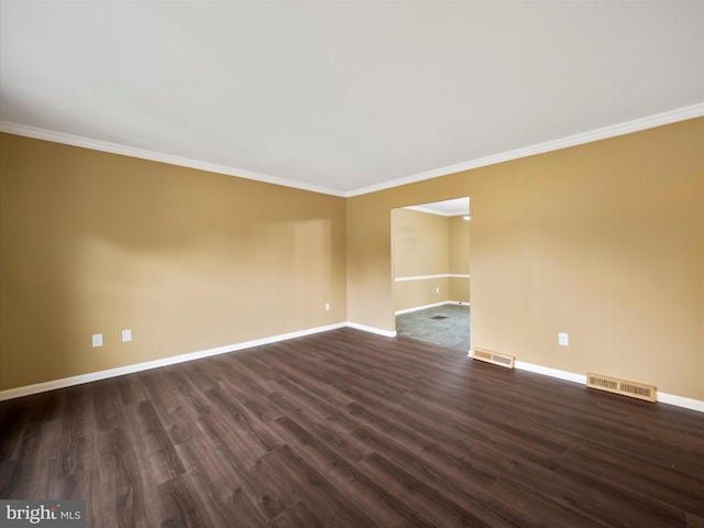 empty room with crown molding and dark hardwood / wood-style floors