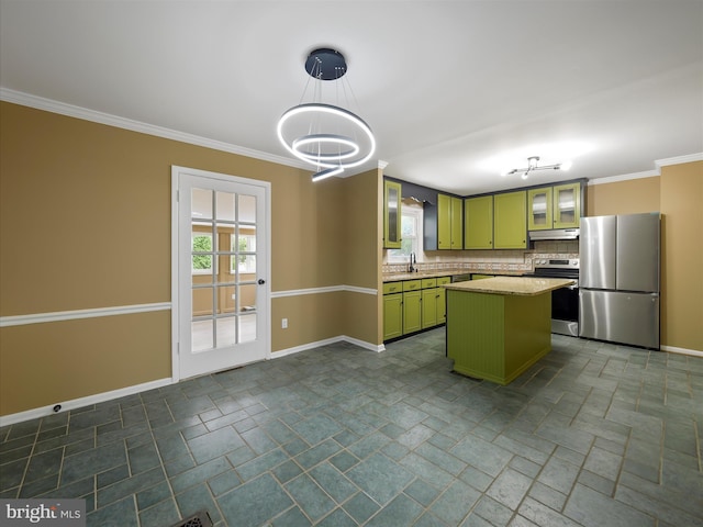 kitchen with pendant lighting, a center island, tasteful backsplash, stainless steel appliances, and green cabinets