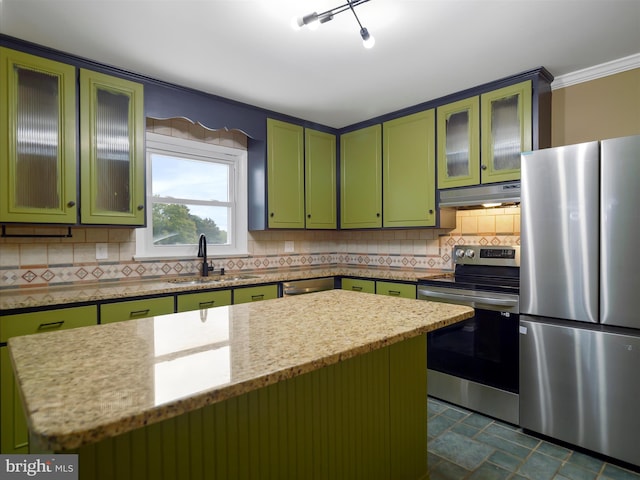 kitchen featuring decorative backsplash, stainless steel appliances, a center island, sink, and green cabinets