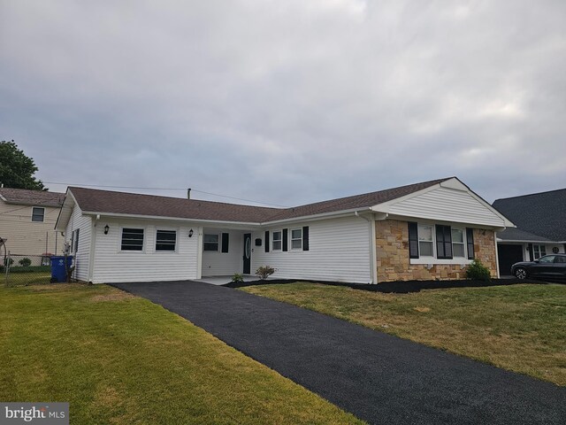 ranch-style house with a front lawn