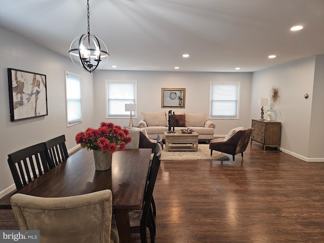 dining room featuring a chandelier, plenty of natural light, and dark wood-type flooring