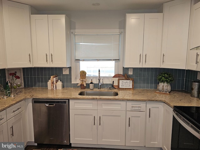 kitchen with light stone counters, sink, white cabinetry, appliances with stainless steel finishes, and decorative backsplash