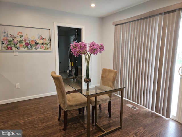 dining room with a healthy amount of sunlight and dark wood-type flooring